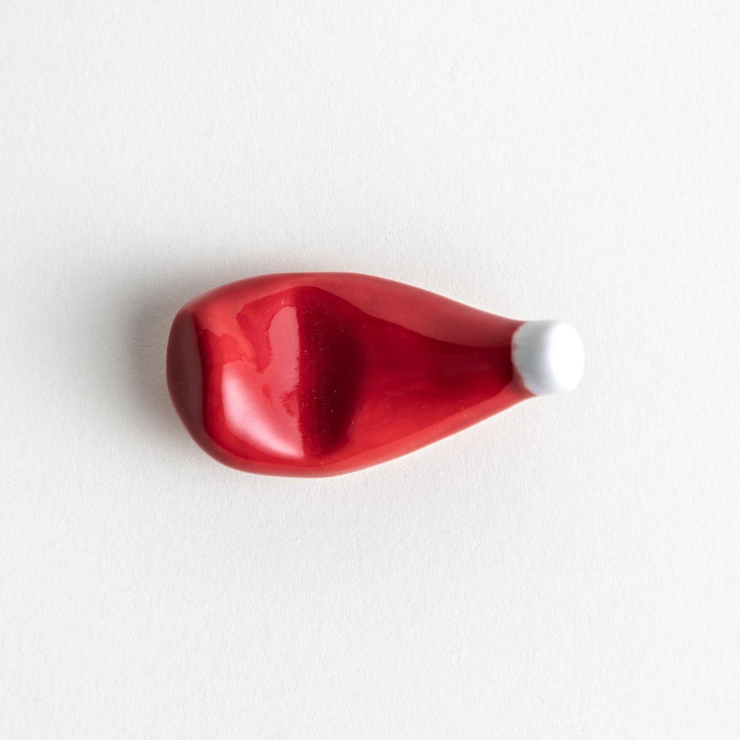 A ceramic chopstick rest resembling a ketchup bottle.