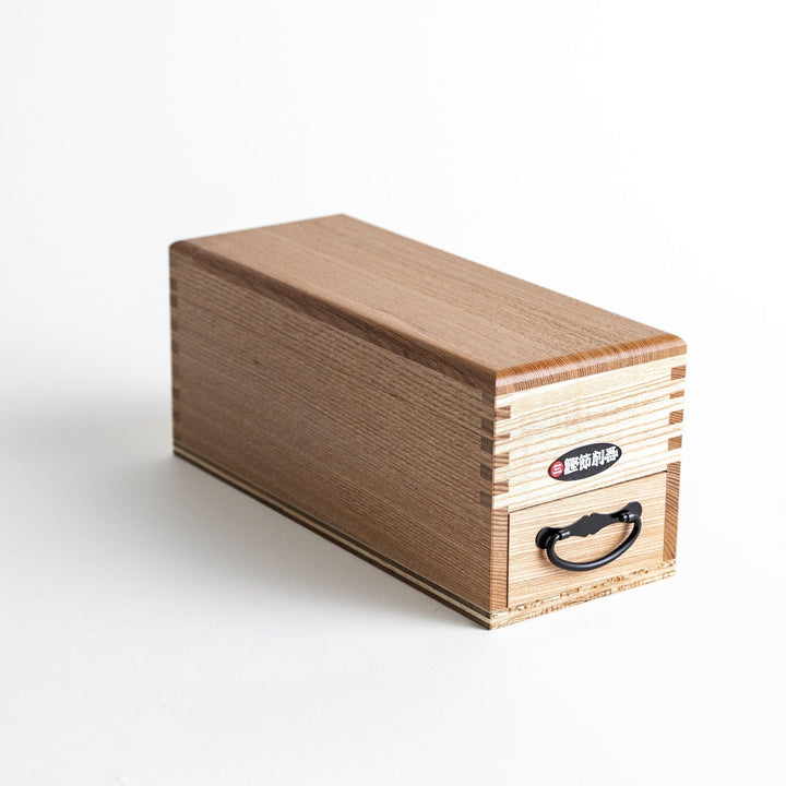 A large wooden box with a sliding drawer and lid, designed for shaving katsuobushi (dried bonito), with a colorful packaging box featuring traditional Japanese artwork.