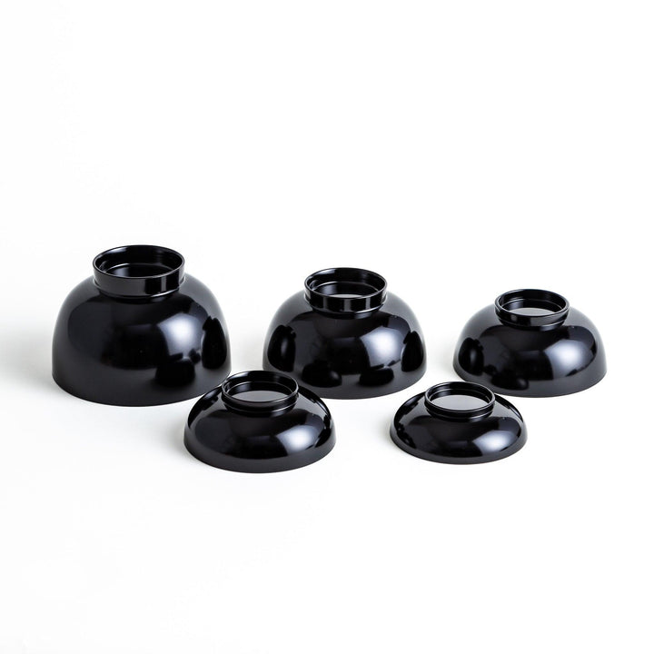 A set of five nested lacquer bowls, each with a footed base, traditionally used in oryoki meals for formal dining settings. Available in black or red.