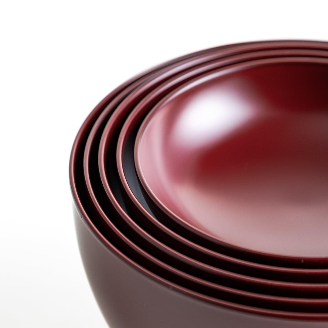 A set of five nested lacquer bowls, each with a footed base, traditionally used in oryoki meals for formal dining settings. Available in black or red.