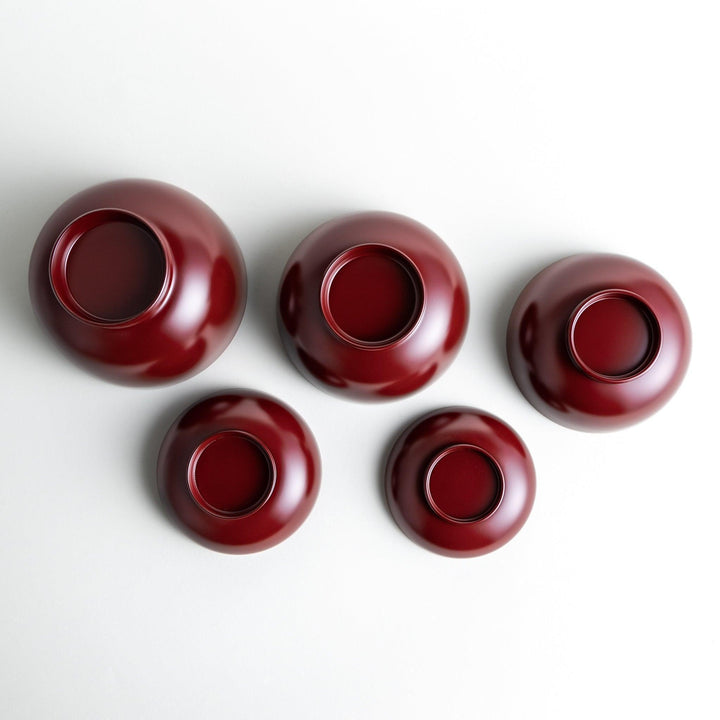 A set of five nested lacquer bowls, each with a footed base, traditionally used in oryoki meals for formal dining settings. Available in black or red.