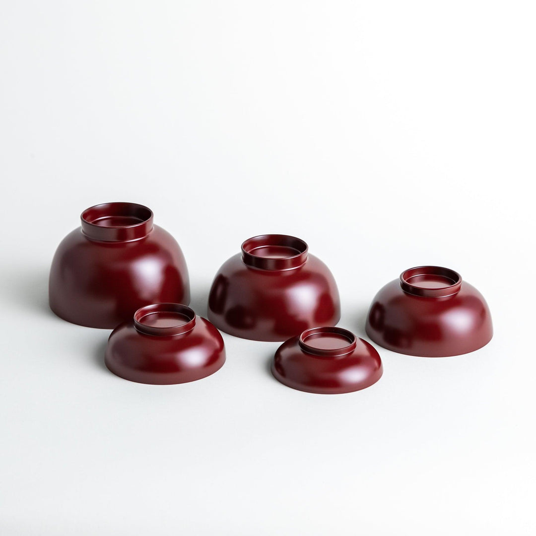 A set of five nested lacquer bowls, each with a footed base, traditionally used in oryoki meals for formal dining settings. Available in black or red.