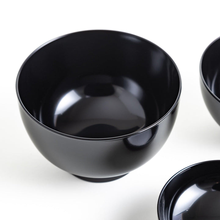 A set of five nested lacquer bowls, each with a footed base, traditionally used in oryoki meals for formal dining settings. Available in black or red.