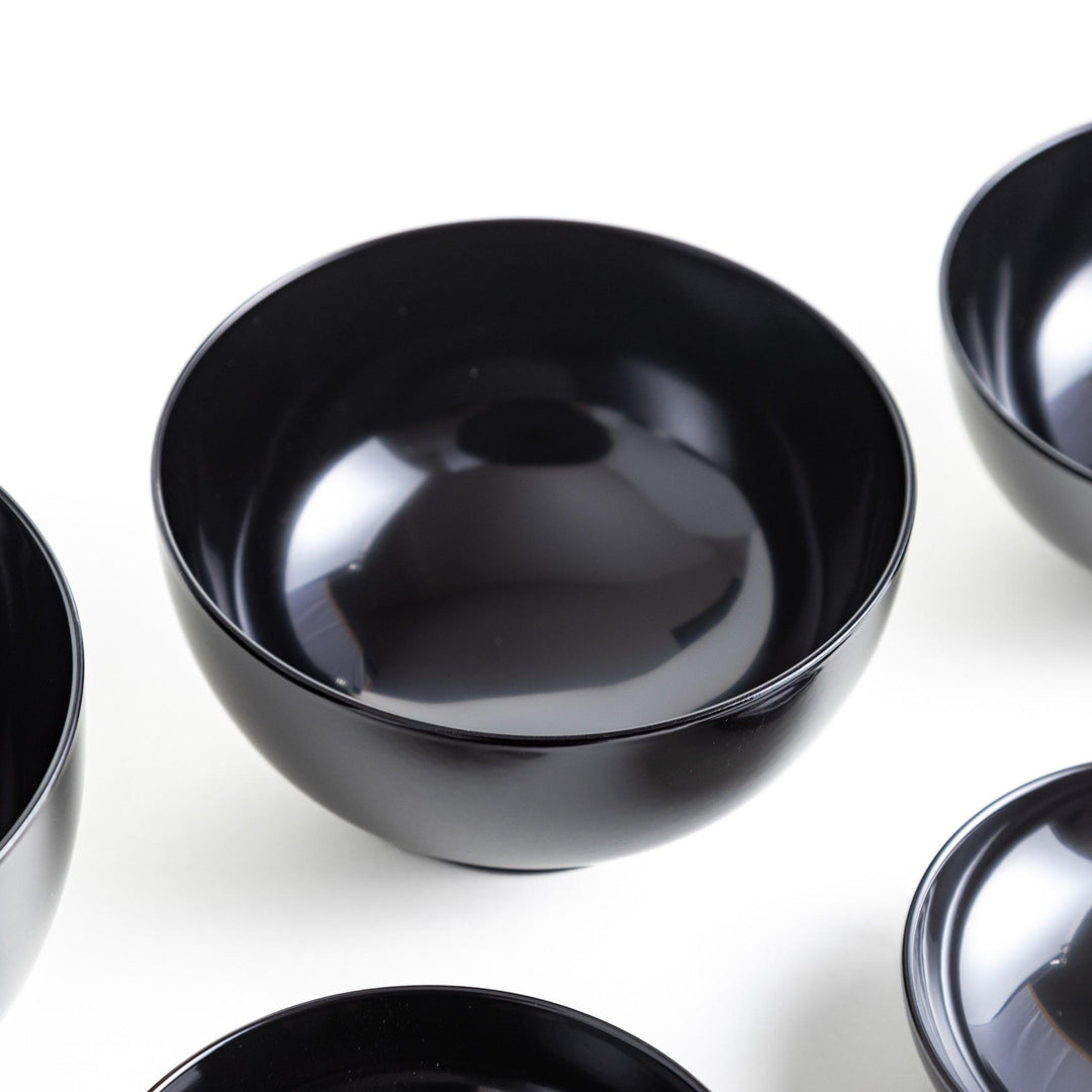 A set of five nested lacquer bowls, each with a footed base, traditionally used in oryoki meals for formal dining settings. Available in black or red.