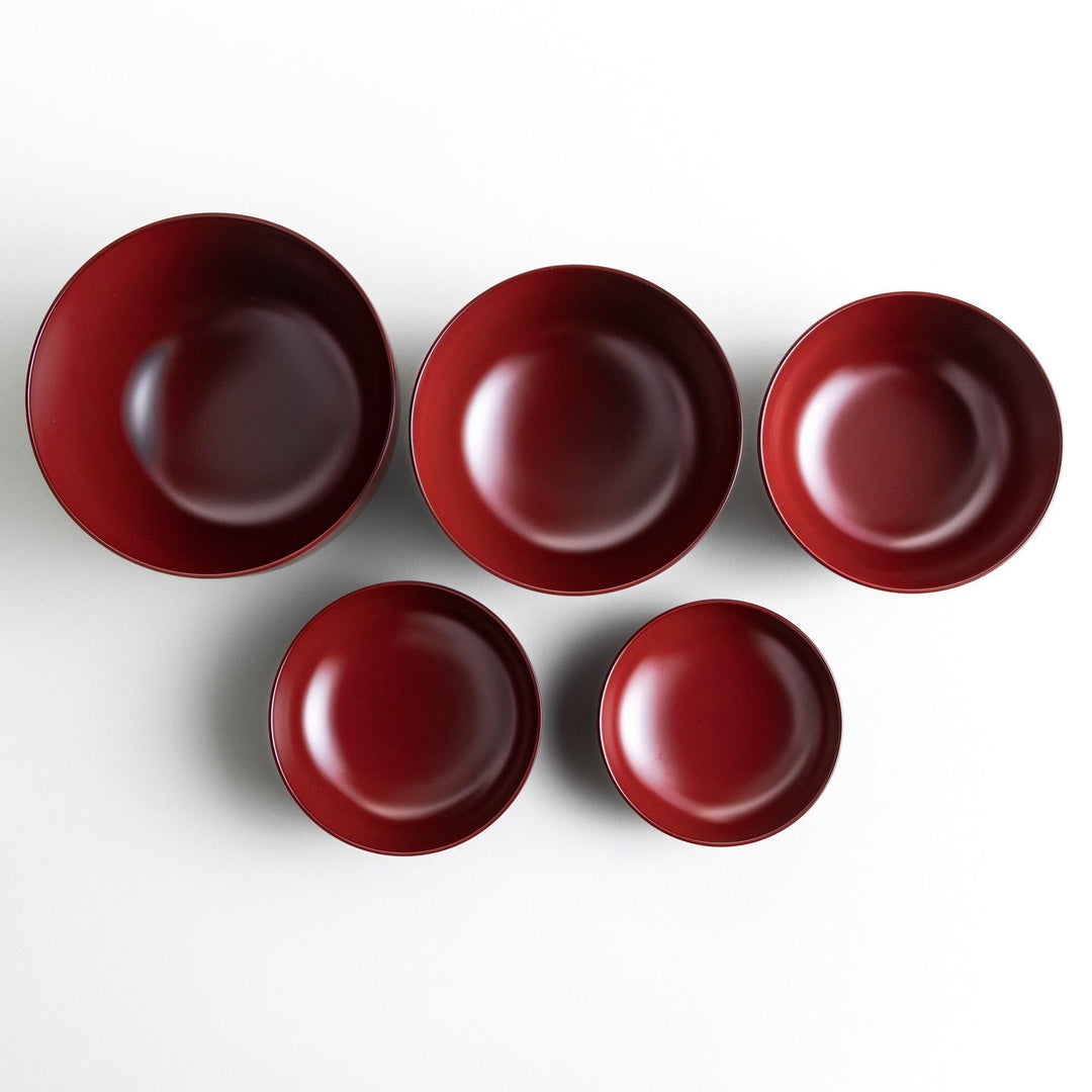 A set of five nested lacquer bowls, each with a footed base, traditionally used in oryoki meals for formal dining settings. Available in black or red.