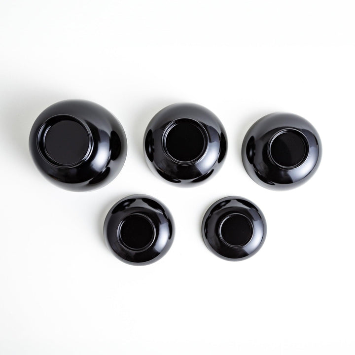 A set of five nested lacquer bowls, each with a footed base, traditionally used in oryoki meals for formal dining settings. Available in black or red.