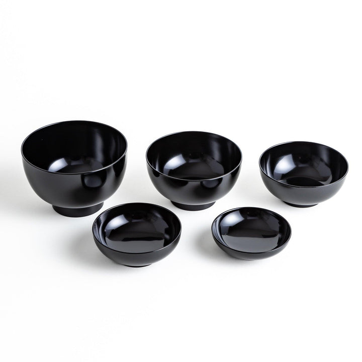 A set of five nested lacquer bowls, each with a footed base, traditionally used in oryoki meals for formal dining settings. Available in black or red.