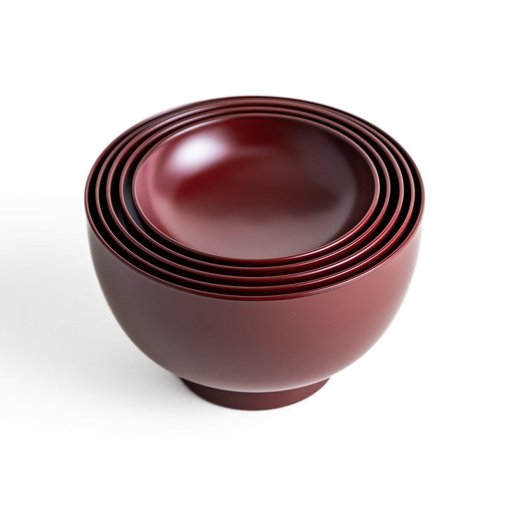 A set of five nested lacquer bowls, each with a footed base, traditionally used in oryoki meals for formal dining settings. Available in black or red.