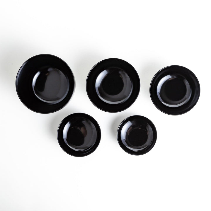 A set of five nested lacquer bowls, each with a footed base, traditionally used in oryoki meals for formal dining settings. Available in black or red.