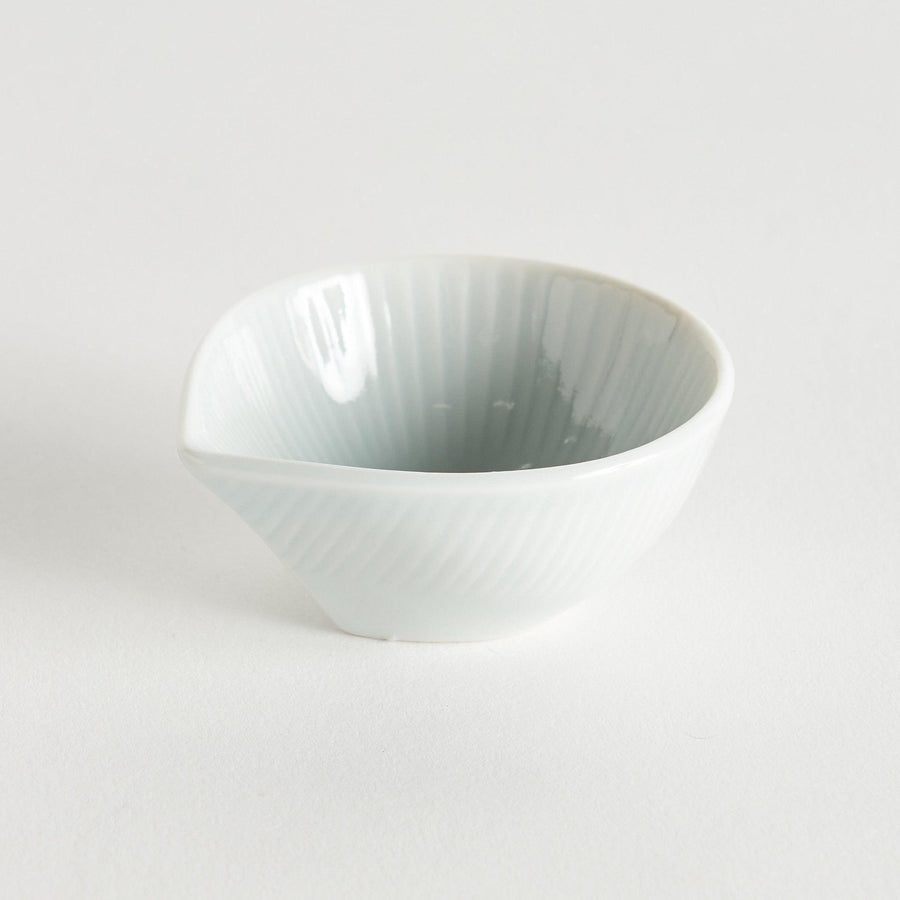 A small white condiment dish with a subtle ribbed pattern.