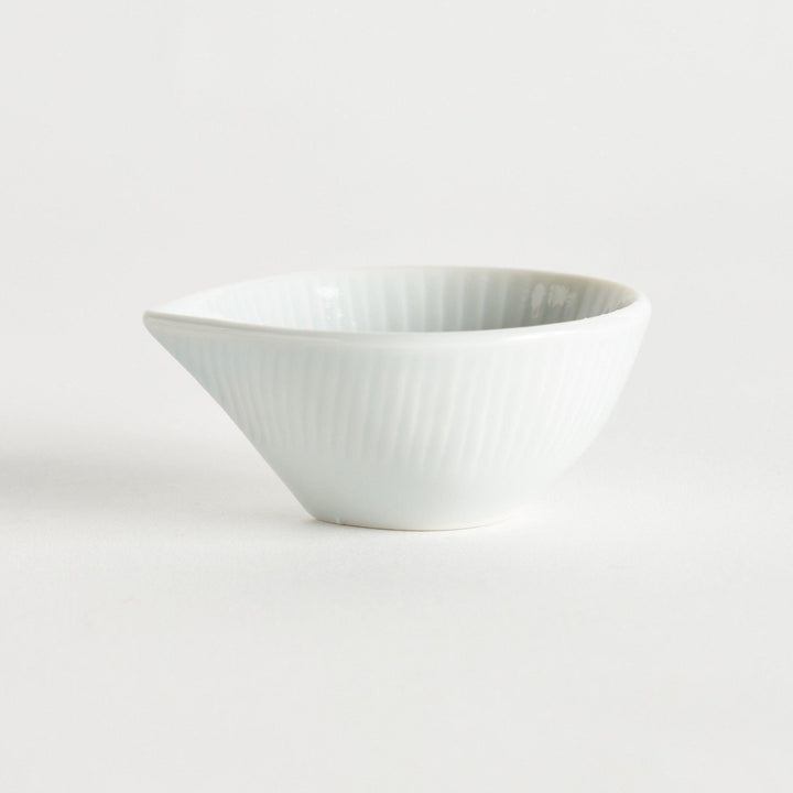 A small white condiment dish with a subtle ribbed pattern.