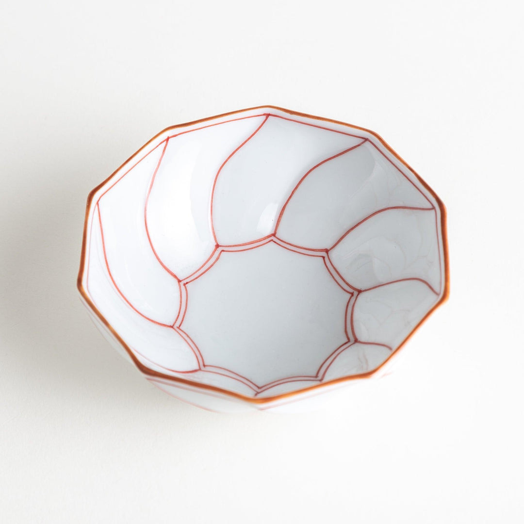 Deep white octagonal dessert bowl with a petal design, outlined in blue or red and finished with a brown rim.