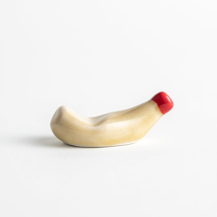 A ceramic chopstick rest resembling a mayonnaise bottle.