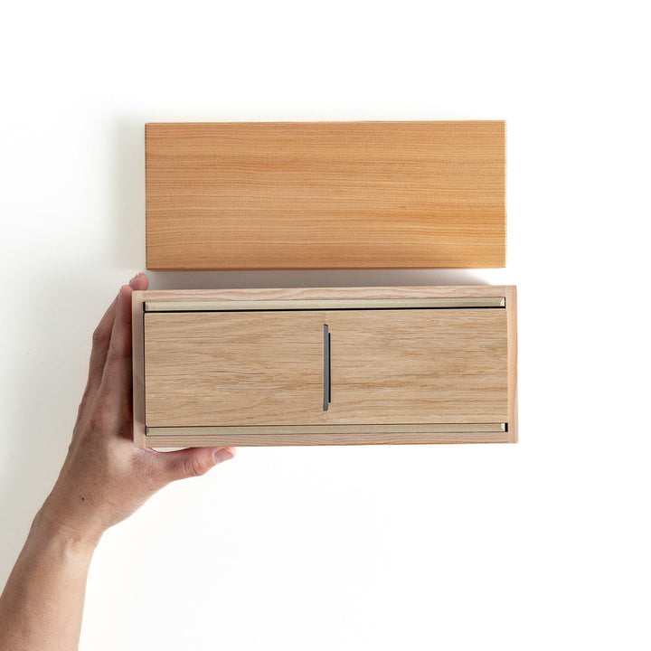 A medium-sized wooden box with a sliding drawer and lid, designed for shaving katsuobushi (dried bonito), with a colorful packaging box featuring traditional Japanese artwork.