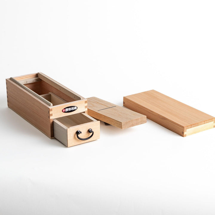 A medium-sized wooden box with a sliding drawer and lid, designed for shaving katsuobushi (dried bonito), with a colorful packaging box featuring traditional Japanese artwork.