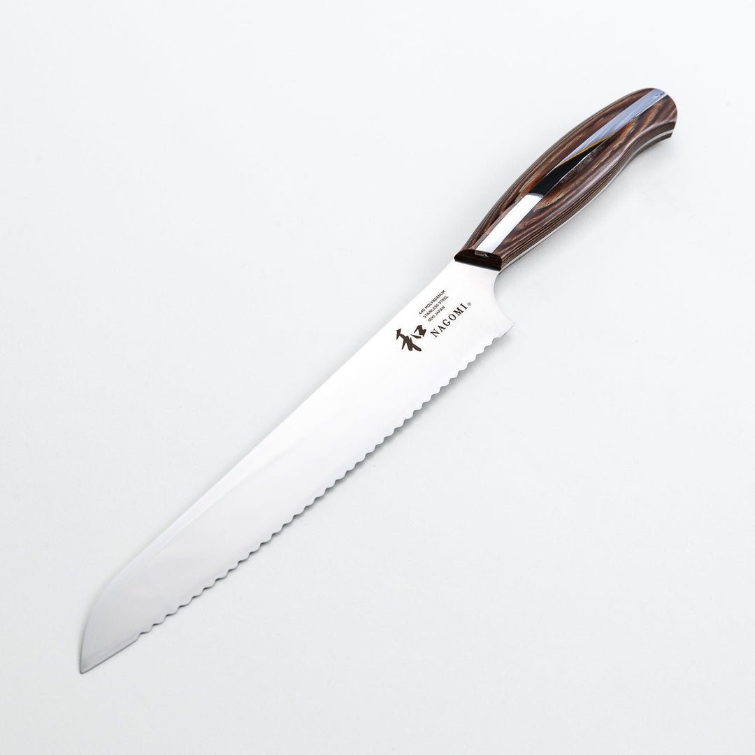 Nagomi bread knife with a serrated stainless steel blade and a polished wooden handle, displayed on a white background.