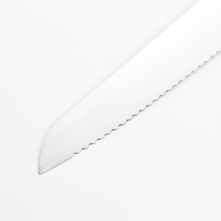 Nagomi bread knife with a serrated stainless steel blade and a polished wooden handle, displayed on a white background.