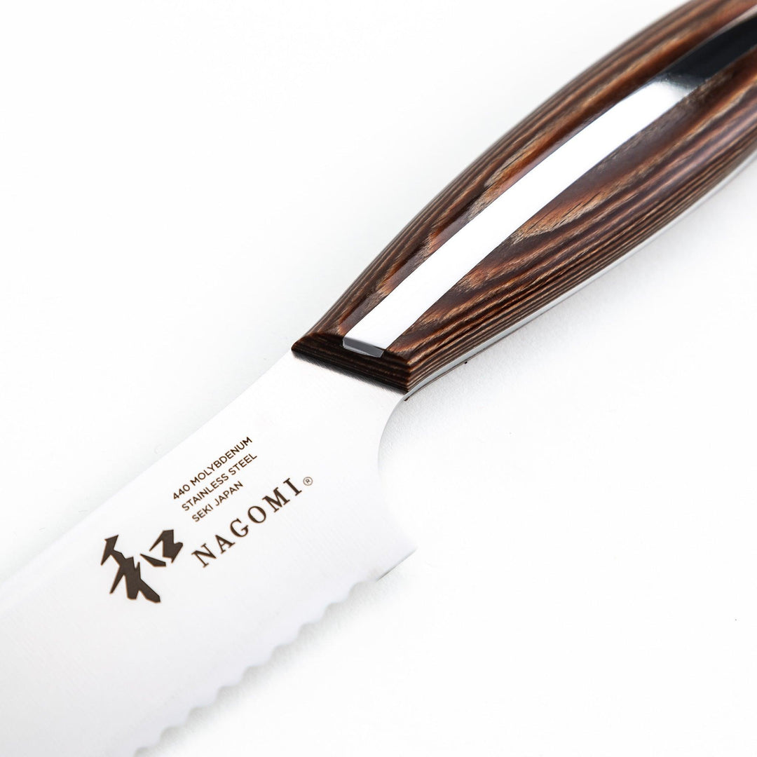 Nagomi bread knife with a serrated stainless steel blade and a polished wooden handle, displayed on a white background.