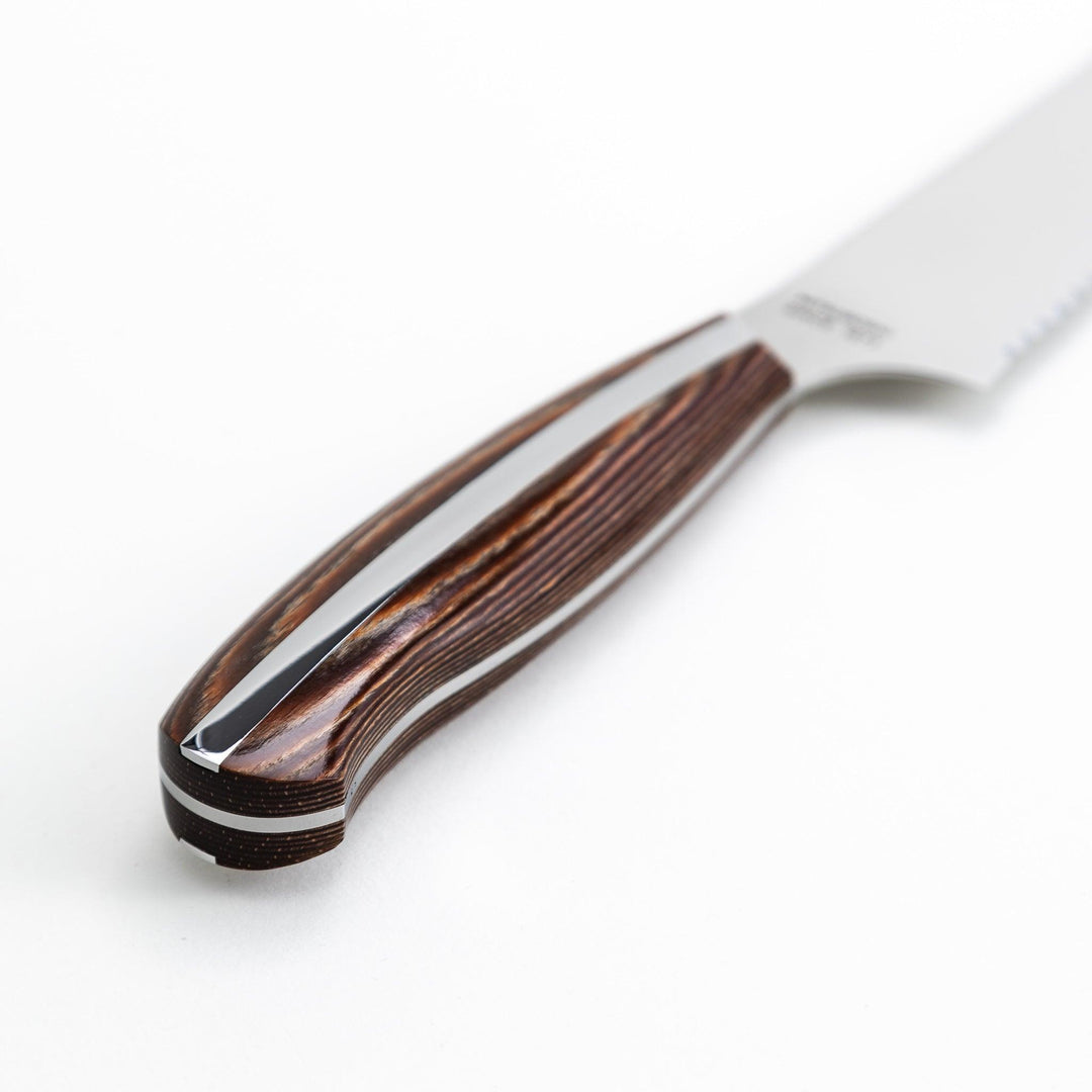 Nagomi bread knife with a serrated stainless steel blade and a polished wooden handle, displayed on a white background.