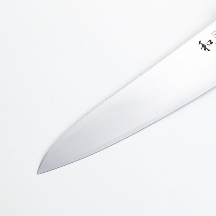 Nagomi chef's knife featuring a stainless steel blade and a sleek wooden handle, displayed on a white background.