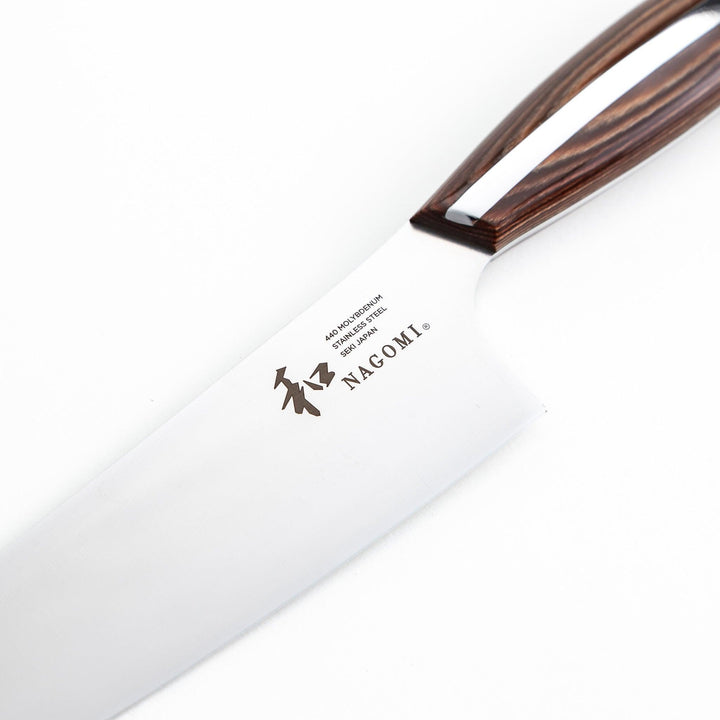 Nagomi chef's knife featuring a stainless steel blade and a sleek wooden handle, displayed on a white background.