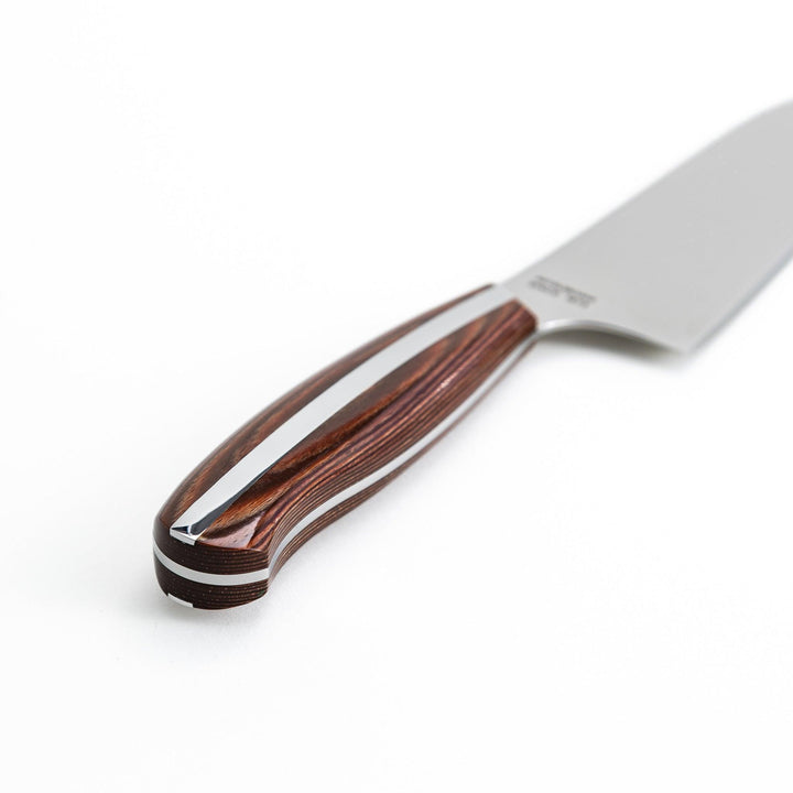 Nagomi Santoku knife with a sharp stainless steel blade and a polished wooden handle, displayed on a white background.