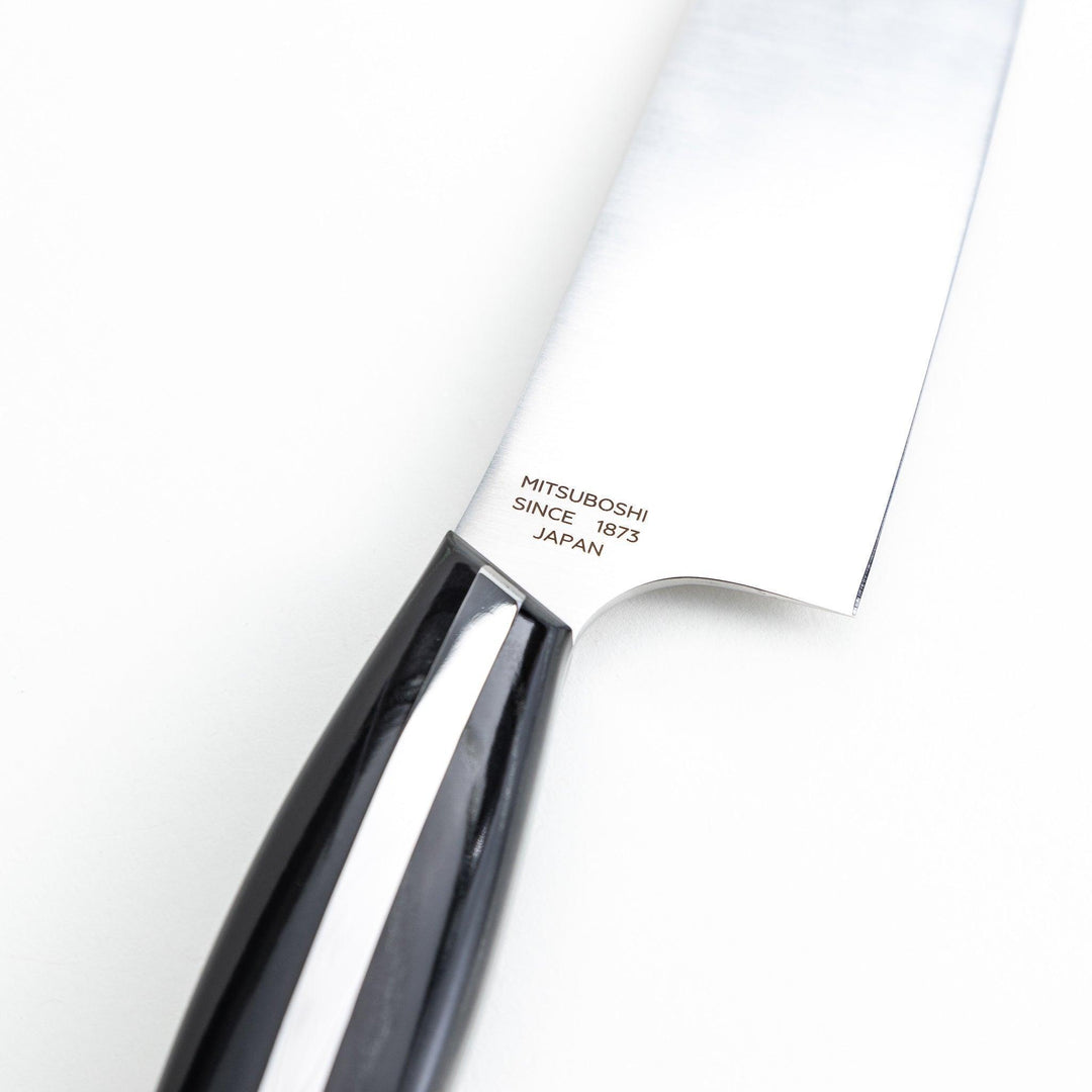 Nagomi professional santouky knife with a stainless steel blade and a black and silver handle, displayed on a dark textured background.