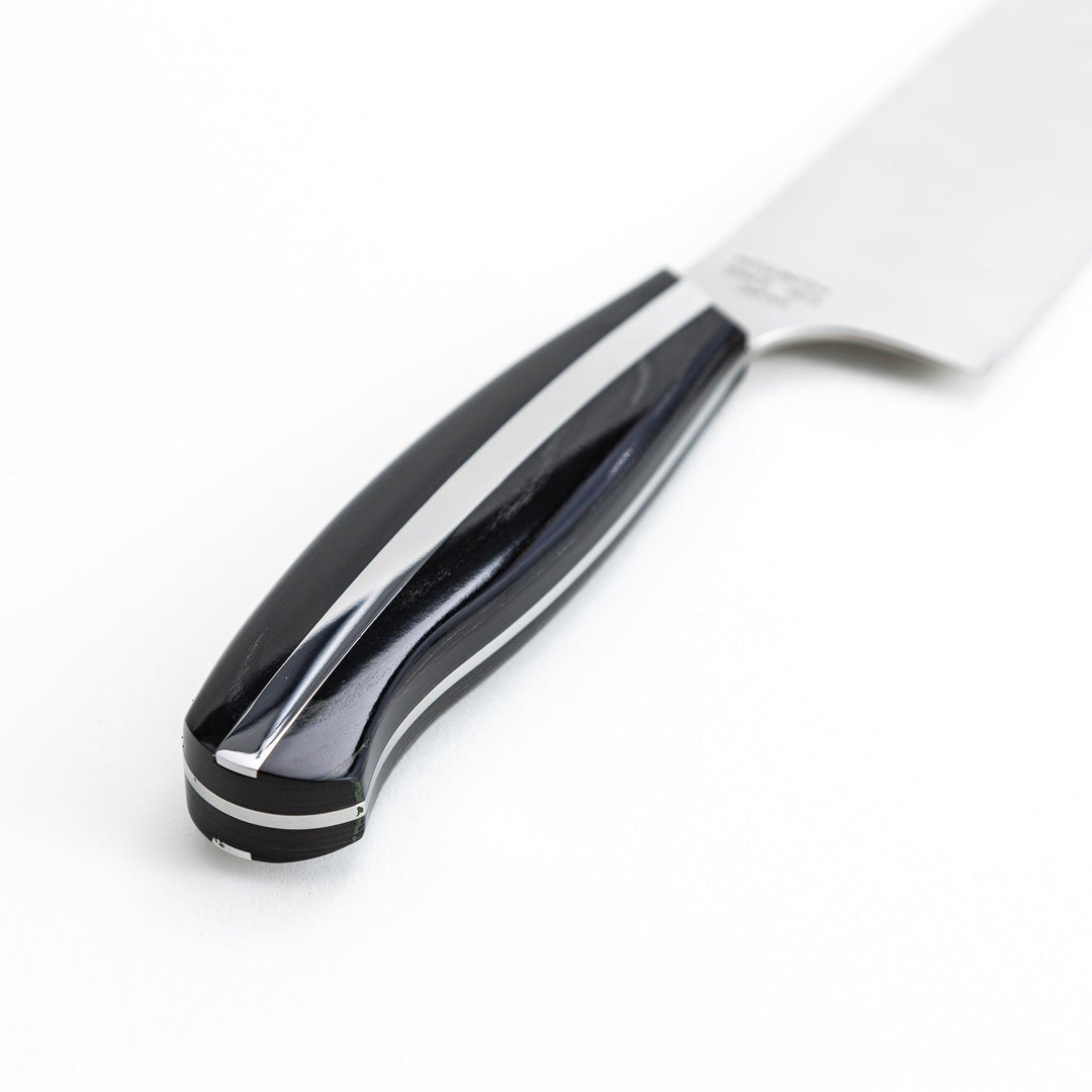 Nagomi professional santouky knife with a stainless steel blade and a black and silver handle, displayed on a dark textured background.