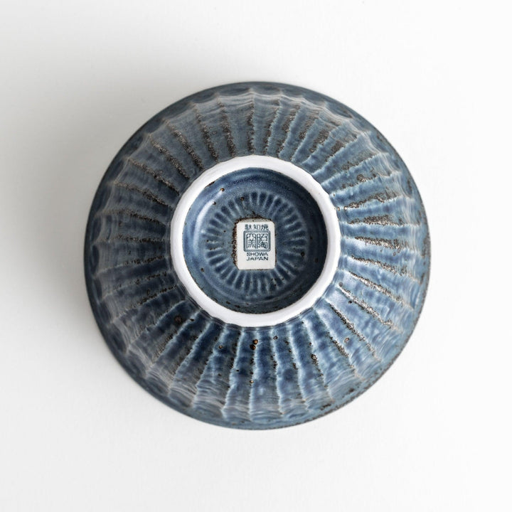 A navy ceramic rice bowl with a natural, rustic texture and a ribbed design.