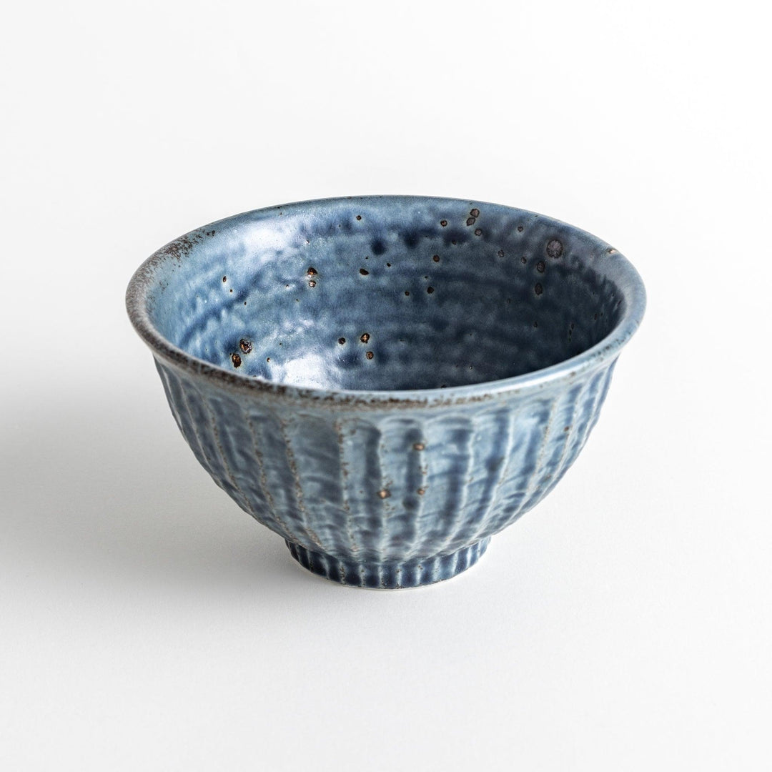 A navy ceramic rice bowl with a natural, rustic texture and a ribbed design.