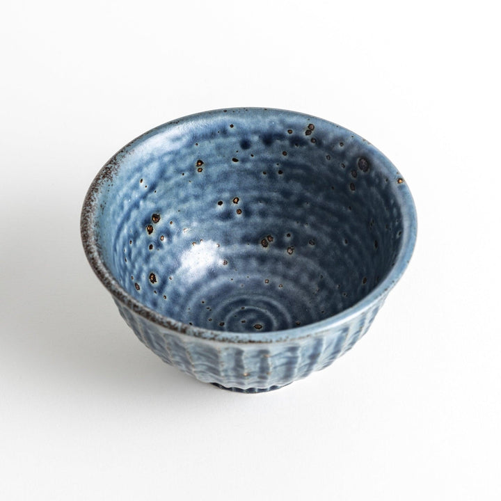 A navy ceramic rice bowl with a natural, rustic texture and a ribbed design.