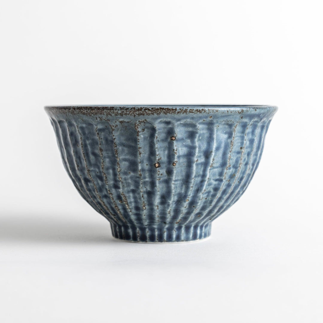 A navy ceramic rice bowl with a natural, rustic texture and a ribbed design.