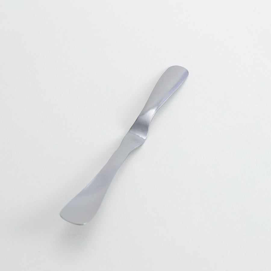 Stainless steel jam spreader with a sleek, double-ended design.