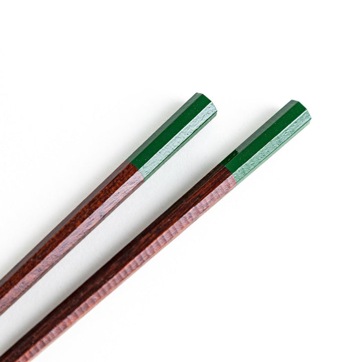 A pair of lacquered chopsticks with octagonal shape and minimalistic design for a sleek and functional dining tool. Available in green or red.