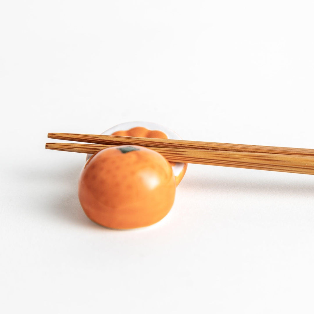 Ceramic chopstick rests shaped like half-cut orange