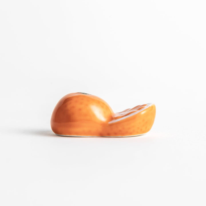 Ceramic chopstick rests shaped like half-cut orange