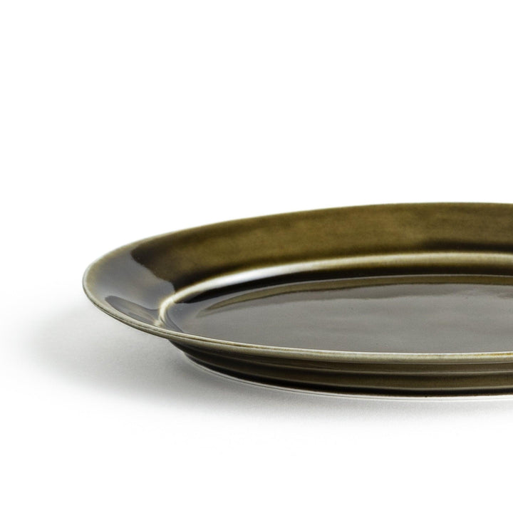 Sleek, dark brown or olive colored oval salad plate with a glossy finish, simple and minimalist.