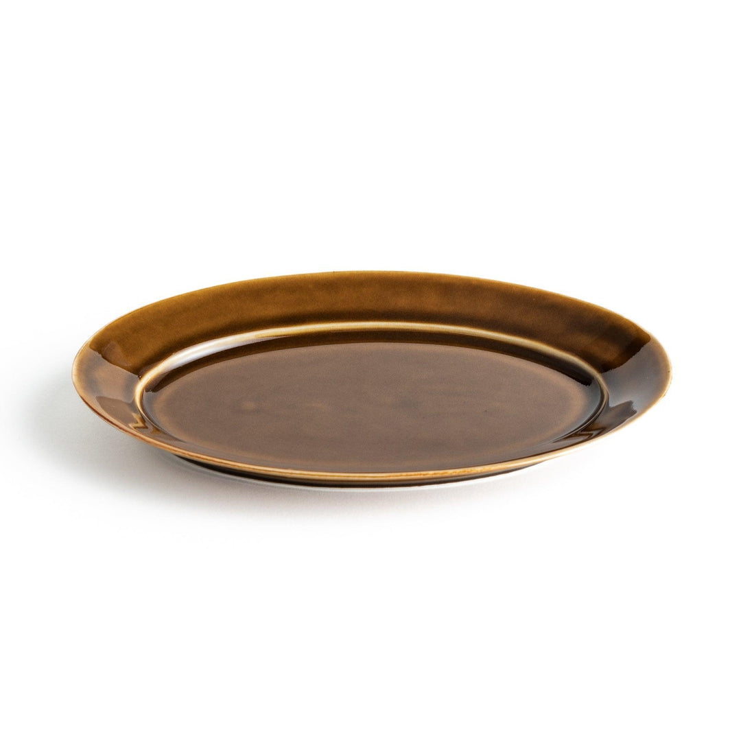 Sleek, dark brown or olive colored oval salad plate with a glossy finish, simple and minimalist.