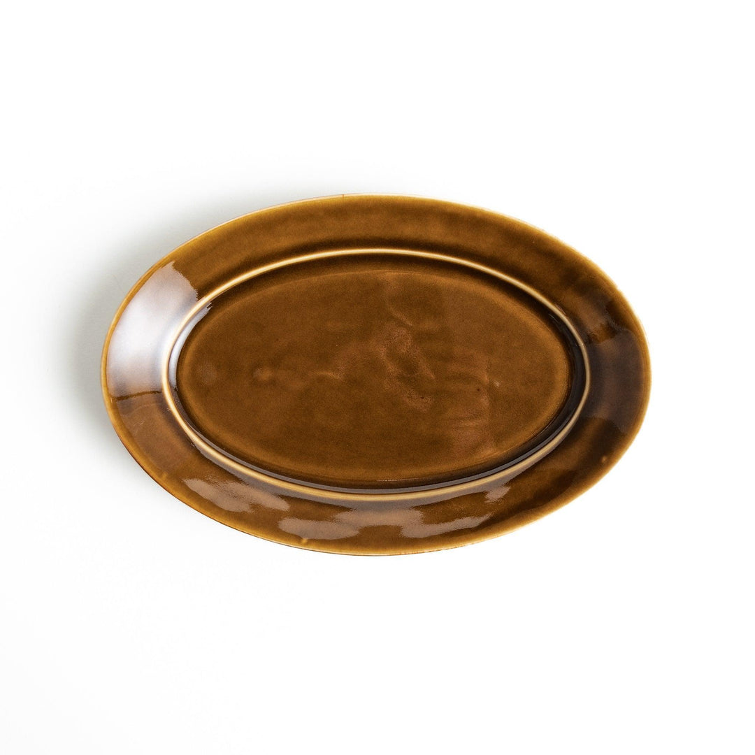 Sleek, dark brown or olive colored oval salad plate with a glossy finish, simple and minimalist.