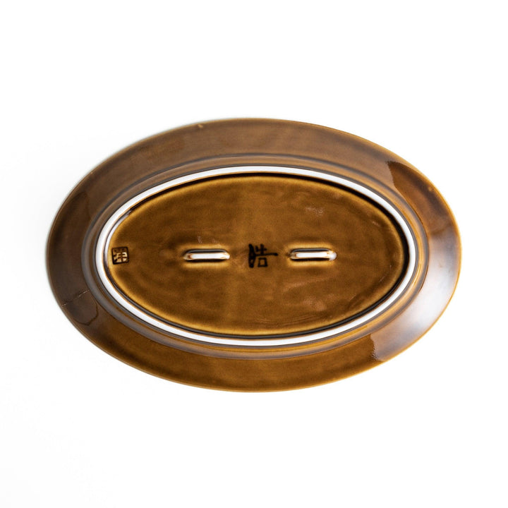 Sleek, dark brown or olive colored oval salad plate with a glossy finish, simple and minimalist.