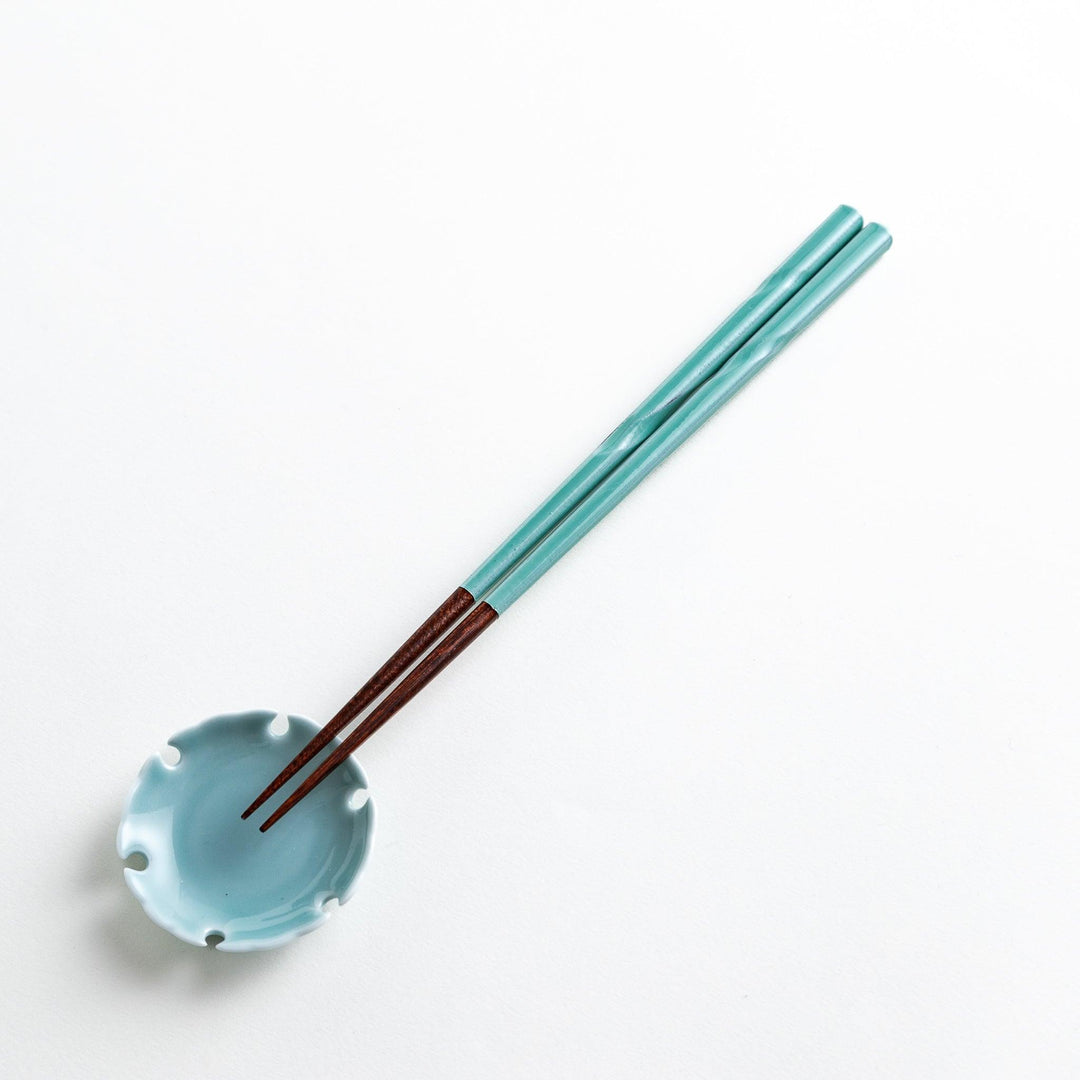 A set of chopsticks with twisted colored tops in soft pastel shades of pink, yellow, green, blue, and gray.