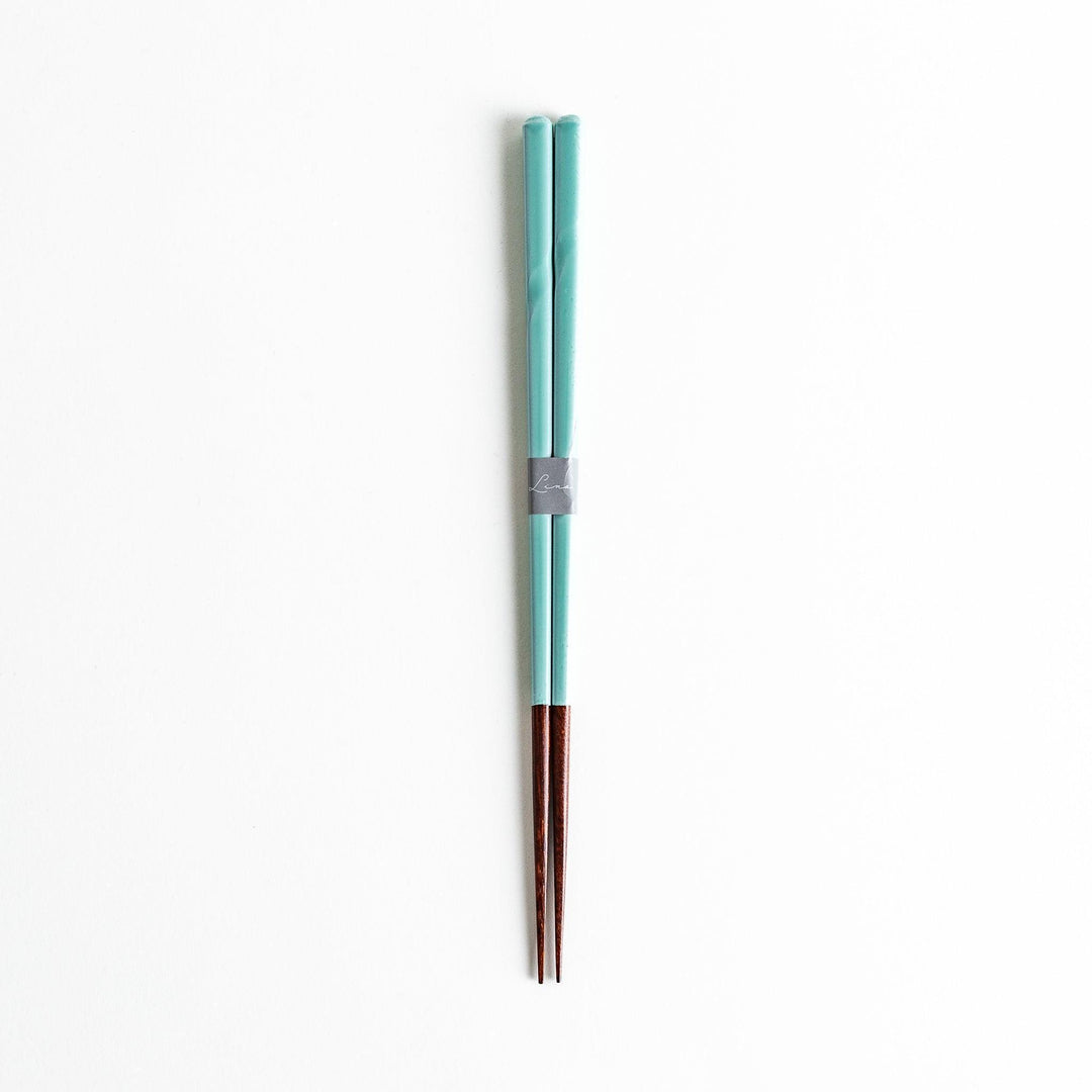 A set of chopsticks with twisted colored tops in soft pastel shades of pink, yellow, green, blue, and gray.