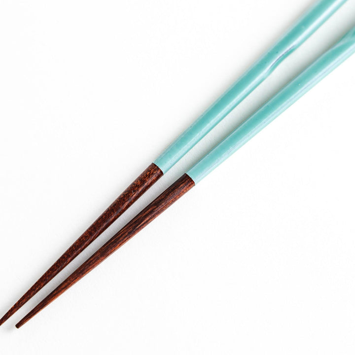 A set of chopsticks with twisted colored tops in soft pastel shades of pink, yellow, green, blue, and gray.