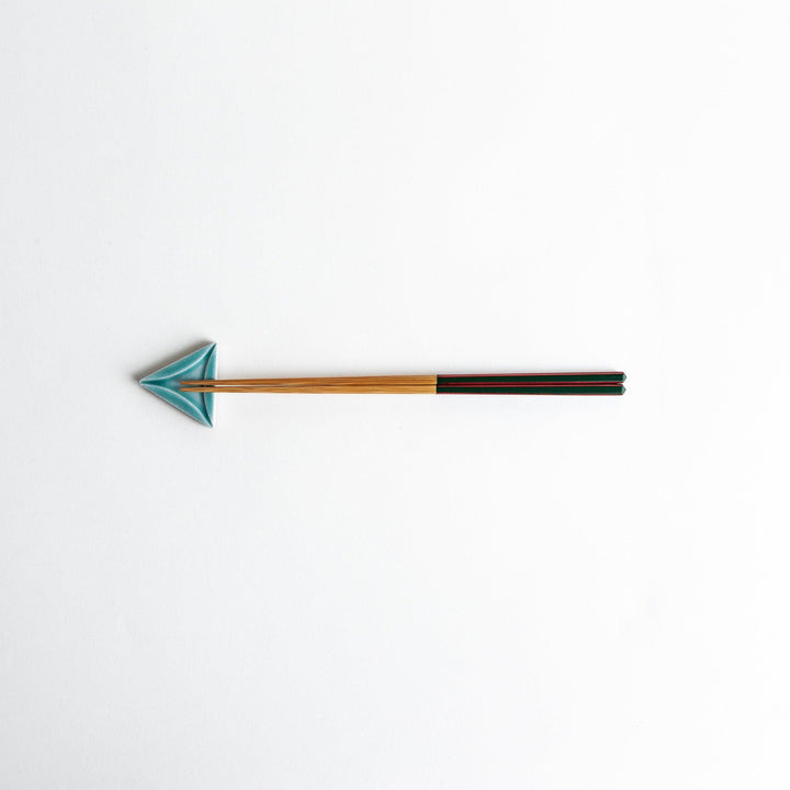 Five small, triangular ceramic chopstick rests in pastel colors—green, brown, blue, turquoise, and gray, arranged randomly on a white background.