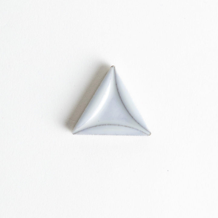 Five small, triangular ceramic chopstick rests in pastel colors—green, brown, blue, turquoise, and gray, arranged randomly on a white background.