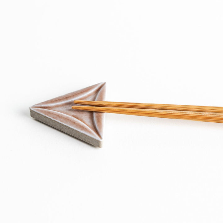 Five small, triangular ceramic chopstick rests in pastel colors—green, brown, blue, turquoise, and gray, arranged randomly on a white background.