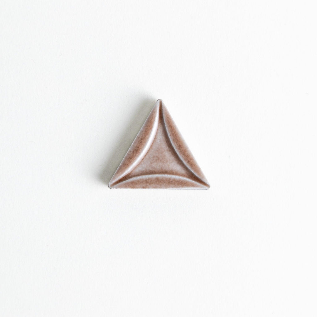 Five small, triangular ceramic chopstick rests in pastel colors—green, brown, blue, turquoise, and gray, arranged randomly on a white background.