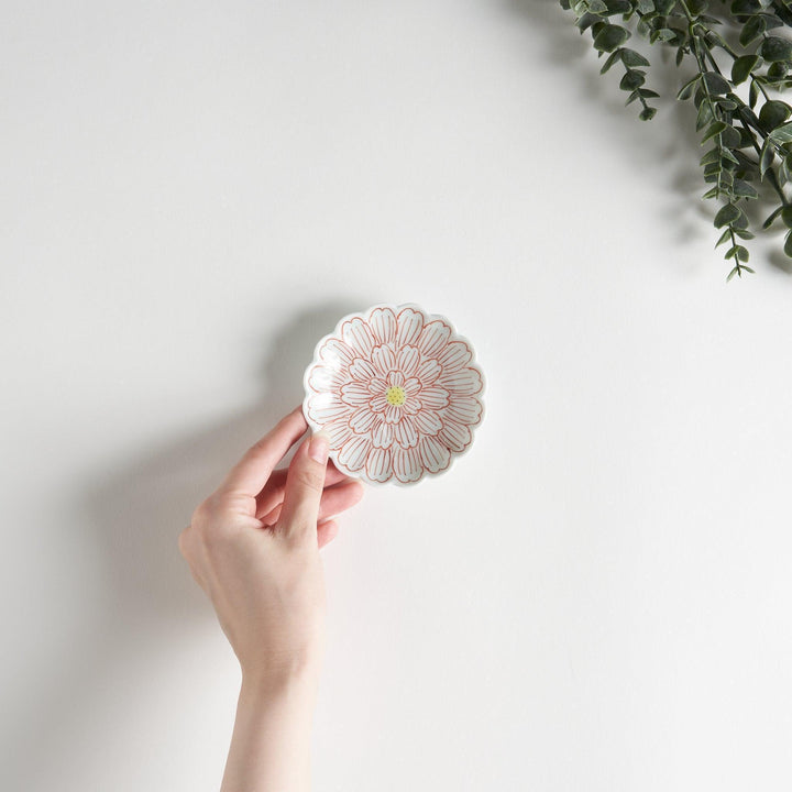 A small round dessert bowl with a delicate blue chrysanthemum pattern and scalloped edges.