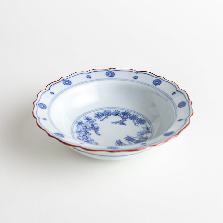 A white ceramic bowl with a blue floral design inside.