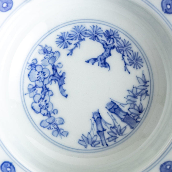 A white ceramic bowl with a blue floral design inside.